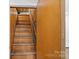 Wooden staircase leading to a finished basement at 1626 S Wendover Rd, Charlotte, NC 28211