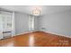 Spacious bedroom with hardwood floors, neutral walls, and plantation shutters at 1626 S Wendover Rd, Charlotte, NC 28211