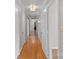 Long hallway with hardwood floors and neutral-colored walls at 1626 S Wendover Rd, Charlotte, NC 28211