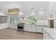 Spacious kitchen boasts white cabinets, marble countertops, and an island at 1626 S Wendover Rd, Charlotte, NC 28211