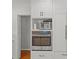 Updated kitchen with built-in microwave and oven in white cabinetry at 1626 S Wendover Rd, Charlotte, NC 28211