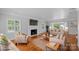 Virtually staged living room with hardwood floors, fireplace and French doors at 1626 S Wendover Rd, Charlotte, NC 28211