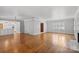 Spacious living room with hardwood floors, fireplace and view into kitchen at 1626 S Wendover Rd, Charlotte, NC 28211