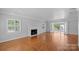 Living room with hardwood floors, fireplace and access to backyard pool at 1626 S Wendover Rd, Charlotte, NC 28211
