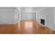 Hardwood floors, fireplace and large windows in this living room at 1626 S Wendover Rd, Charlotte, NC 28211