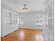 Home office with hardwood floors, built-in shelving, and neutral walls at 1626 S Wendover Rd, Charlotte, NC 28211