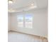 Well-lit bedroom with two large windows and carpet flooring at 2070 Van Buren Rd, Sherrills Ford, NC 28673