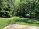 Backyard featuring a spacious lawn and mature trees at 1111 S Skyland Dr, Mount Pleasant, NC 28124
