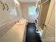 Bathroom featuring a lengthy vanity, stacked washer and dryer and neutral walls at 1111 S Skyland Dr, Mount Pleasant, NC 28124