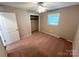 Bedroom featuring neutral walls, carpeted floors, a ceiling fan, and a closet space, with natural lighting at 1111 S Skyland Dr, Mount Pleasant, NC 28124