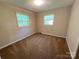 Bedroom features carpeted floors, neutral walls and bright natural light from the two windows at 1111 S Skyland Dr, Mount Pleasant, NC 28124