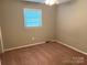 Cozy bedroom features carpeted floors, a ceiling fan, neutral walls, and natural lighting from the window at 1111 S Skyland Dr, Mount Pleasant, NC 28124