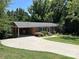 Lovely brick house with an attached carport, blue shutters, and a well-manicured lawn at 1111 S Skyland Dr, Mount Pleasant, NC 28124