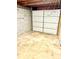 Unfinished garage space showcasing a new garage door at 1111 S Skyland Dr, Mount Pleasant, NC 28124