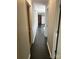 Hallway with neutral walls and dark tile flooring leads to other rooms, including the kitchen and bedrooms at 1111 S Skyland Dr, Mount Pleasant, NC 28124