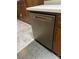 Built-in stainless steel dishwasher with wooden cabinetry, seamlessly blending function and design in the kitchen at 1111 S Skyland Dr, Mount Pleasant, NC 28124