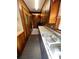 A well-lit kitchen showcasing wood cabinets, stainless steel sink, and a mix of classic and modern design elements at 1111 S Skyland Dr, Mount Pleasant, NC 28124
