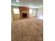 Bright living room featuring a brick fireplace, and neutral walls with two large windows at 1111 S Skyland Dr, Mount Pleasant, NC 28124