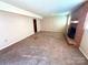 Spacious living room featuring a brick fireplace, neutral walls, and carpet floors at 1111 S Skyland Dr, Mount Pleasant, NC 28124