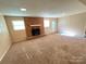 Spacious living room featuring a brick fireplace, neutral walls and new carpet at 1111 S Skyland Dr, Mount Pleasant, NC 28124
