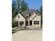 Charming, newly constructed home features a brick facade, large windows, and an attached two-car garage at 1211 Royal Prince Ct, Charlotte, NC 28211