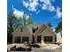 Charming new construction home featuring a gray brick facade, two-car garage, and a well-manicured lawn at 1211 Royal Prince Ct, Charlotte, NC 28211