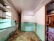 The basement features built-in shelving, a large sink, and green and white tile flooring at 12770 Bringle Ferry Rd, Richfield, NC 28137