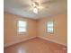 This cozy bedroom features gleaming hardwood floors and large windows that let in plenty of light at 12770 Bringle Ferry Rd, Richfield, NC 28137