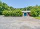 Detached garage with dual entries, surrounded by lush greenery and a gravel lot at 12770 Bringle Ferry Rd, Richfield, NC 28137