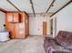 Garage with a water heater and a leather chair, showing potential for a workshop or storage at 12770 Bringle Ferry Rd, Richfield, NC 28137