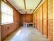 Unfinished garage interior featuring exposed studs, a work table, and natural light at 12770 Bringle Ferry Rd, Richfield, NC 28137