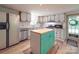 Kitchen with white cabinets, an island, and stainless steel appliances at 12770 Bringle Ferry Rd, Richfield, NC 28137