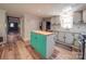 Kitchen with white cabinets, stainless steel appliances, a colorful kitchen island and hardwood floors at 12770 Bringle Ferry Rd, Richfield, NC 28137