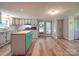 Charming kitchen with an island, white cabinets, wood floors, and stainless steel appliances at 12770 Bringle Ferry Rd, Richfield, NC 28137