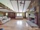 Comfortable living room with hardwood floors, wood paneled walls, a fireplace, and lots of natural light at 12770 Bringle Ferry Rd, Richfield, NC 28137