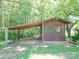 This outbuilding with a covered parking area is surrounded by lush greenery at 12770 Bringle Ferry Rd, Richfield, NC 28137