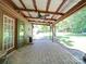 Covered brick patio with a ceiling fan and views of the spacious, tree-filled backyard at 12770 Bringle Ferry Rd, Richfield, NC 28137