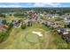 Stunning aerial view of a home near a golf course, surrounded by lush greenery and a tranquil pond at 135 Tenth Green Ct, Statesville, NC 28677