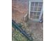 Exterior view of basement foundation with drain pipe at 705 Neil St, Gastonia, NC 28052