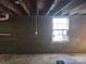 Unfinished basement wall with window and electrical outlet at 705 Neil St, Gastonia, NC 28052