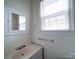 Bathroom with sink, medicine cabinet, and window with blinds at 705 Neil St, Gastonia, NC 28052