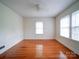 Spacious bedroom with hardwood floors and two large windows at 705 Neil St, Gastonia, NC 28052