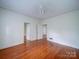 Hardwood floor bedroom with multiple doors to other rooms at 705 Neil St, Gastonia, NC 28052