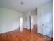 Hardwood floor bedroom with doors to other rooms and windows at 705 Neil St, Gastonia, NC 28052