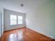 Bedroom with hardwood floors and a double window at 705 Neil St, Gastonia, NC 28052