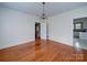 Spacious dining room with hardwood floors, chandelier, and views to kitchen at 705 Neil St, Gastonia, NC 28052