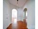 Entryway with hardwood floors and arched doorways leading to other rooms at 705 Neil St, Gastonia, NC 28052