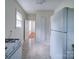 Kitchen with white appliances, tile floor, and view into another room at 705 Neil St, Gastonia, NC 28052