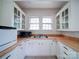 White kitchen with wood countertops, microwave, and double sink at 705 Neil St, Gastonia, NC 28052