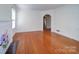 Hardwood floor living room with fireplace, archway, and lots of natural light at 705 Neil St, Gastonia, NC 28052